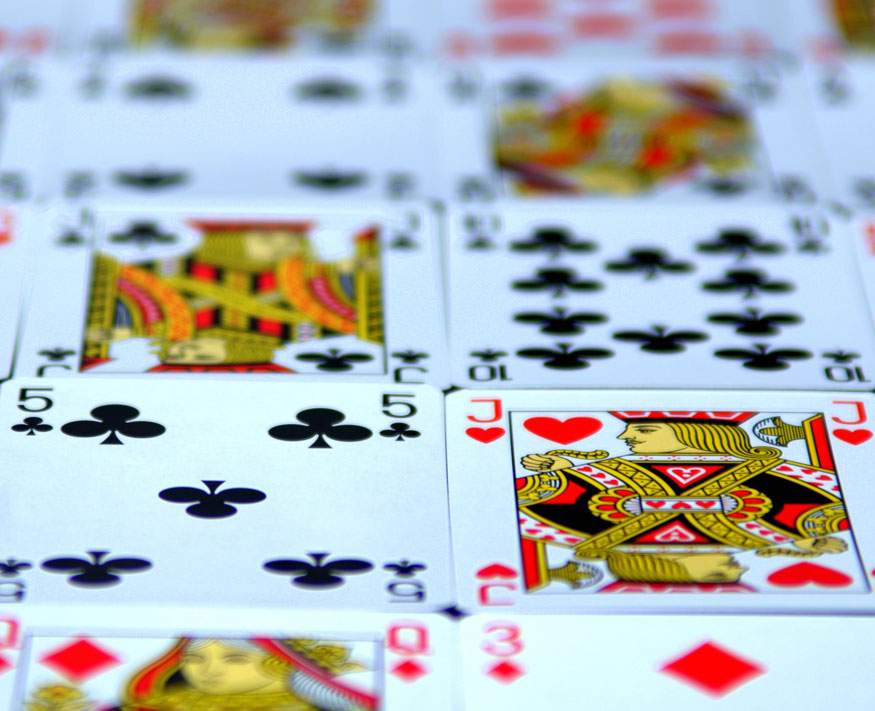 Gambling Cards lay on the table in row 